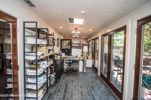 4609 10th St, Lubbock, TX 79416 - office space featuring brick patterned flooring, recessed lighting, french doors, and a chandelier