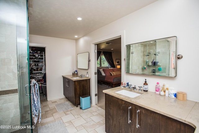 4609 10th St, Lubbock, TX 79416 - ensuite bathroom featuring a stall shower, vanity, stone finish floors, and recessed lighting