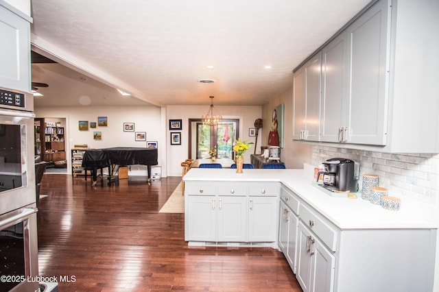 4609 10th St, Lubbock, TX 79416 - kitchen with a peninsula, light countertops, backsplash, dark wood-type flooring, and recessed lighting