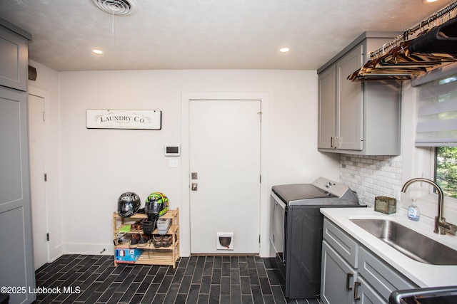 4609 10th St, Lubbock, TX 79416 - laundry area featuring washer and clothes dryer, cabinet space, recessed lighting, and baseboards