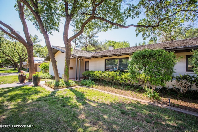 4609 10th St, Lubbock, TX 79416 - ranch-style home with brick siding, a chimney, and a front lawn