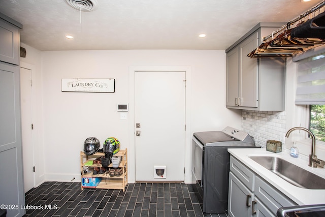 4609 10th St, Lubbock, TX 79416 - washroom with washing machine and dryer, cabinet space, recessed lighting, and baseboards