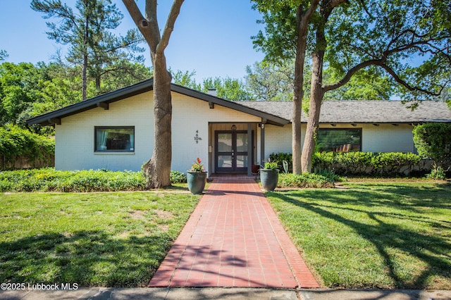 4609 10th St, Lubbock, TX 79416 - mid-century inspired home featuring french doors, brick siding, and a front yard