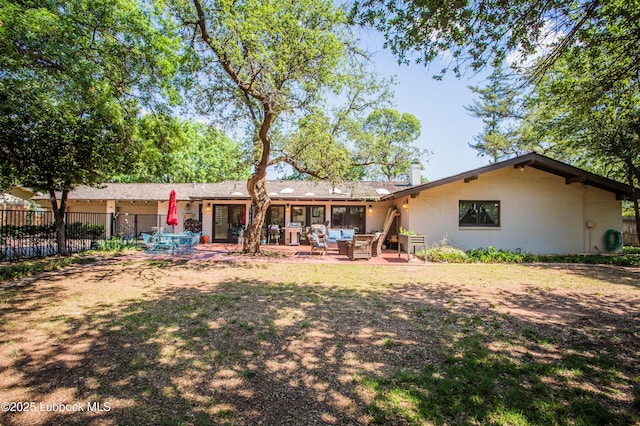 4609 10th St, Lubbock, TX 79416 - rear view of house featuring a patio, an outdoor living space, brick siding, and a chimney