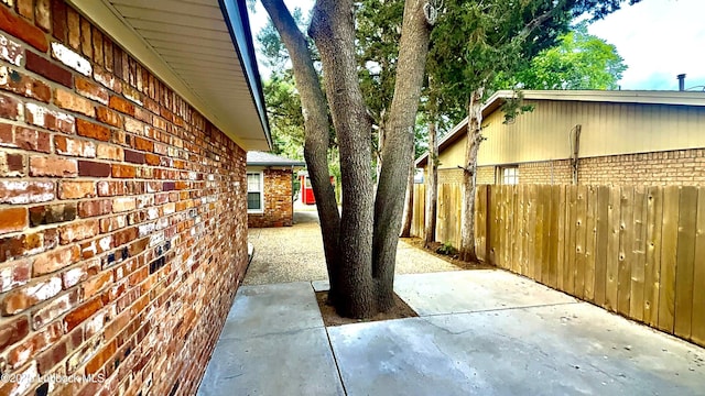 3806 56th St, Lubbock, TX 79413 - view of side of home featuring brick siding and a patio area