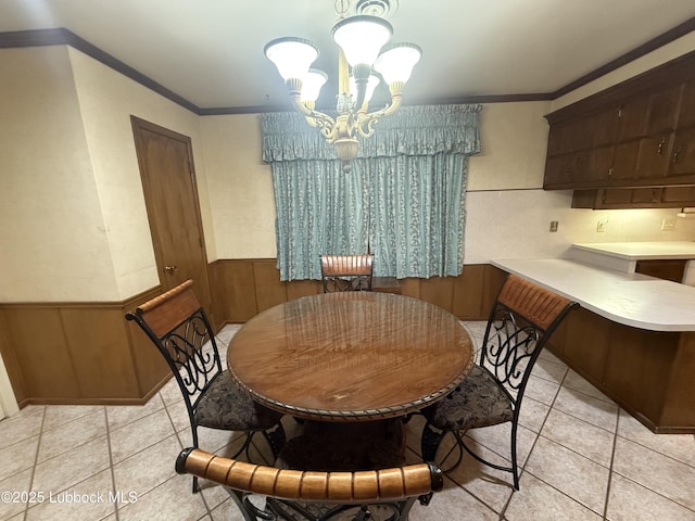 3806 56th St, Lubbock, TX 79413 - dining area with light tile patterned floors, ornamental molding, a chandelier, and wainscoting