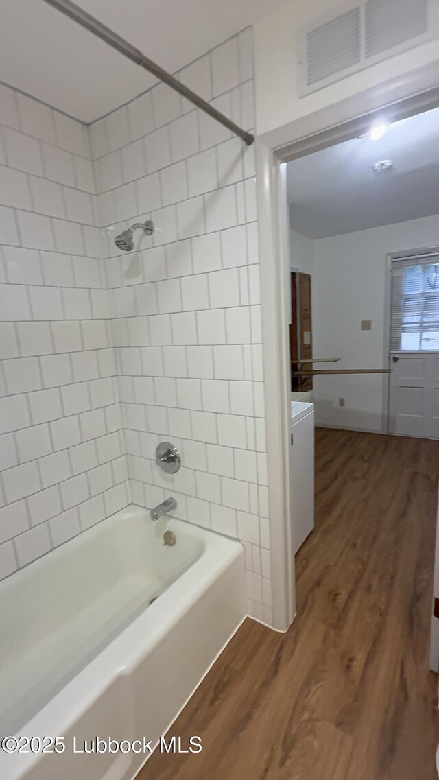 3806 56th St, Lubbock, TX 79413 - full bathroom with wood finished floors, vanity, and tub / shower combination
