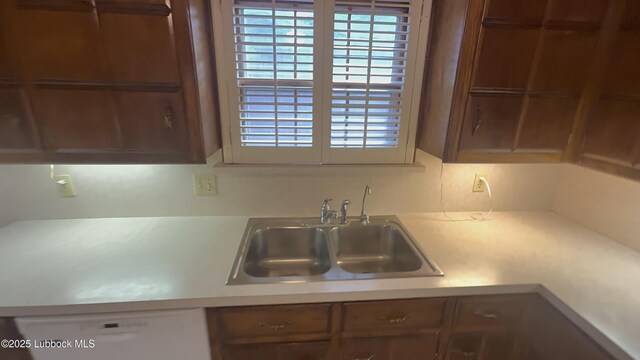 3806 56th St, Lubbock, TX 79413 - kitchen featuring dishwasher, a sink, and light countertops