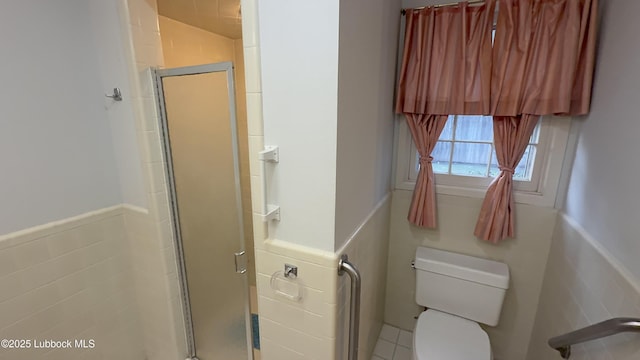3806 56th St, Lubbock, TX 79413 - full bath with tile walls, a wainscoted wall, and a stall shower