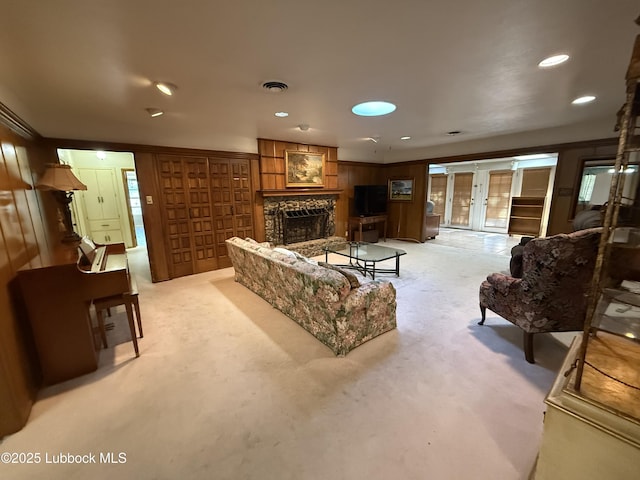3806 56th St, Lubbock, TX 79413 - living area with light carpet, a fireplace with raised hearth, french doors, and recessed lighting
