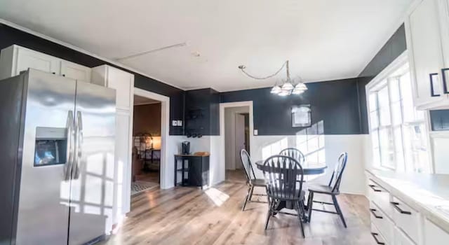 dining space featuring a chandelier and light hardwood / wood-style floors