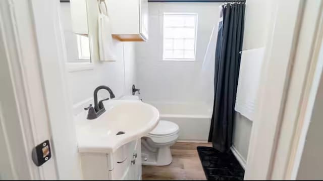 full bathroom featuring shower / bathtub combination with curtain, vanity, hardwood / wood-style flooring, and toilet