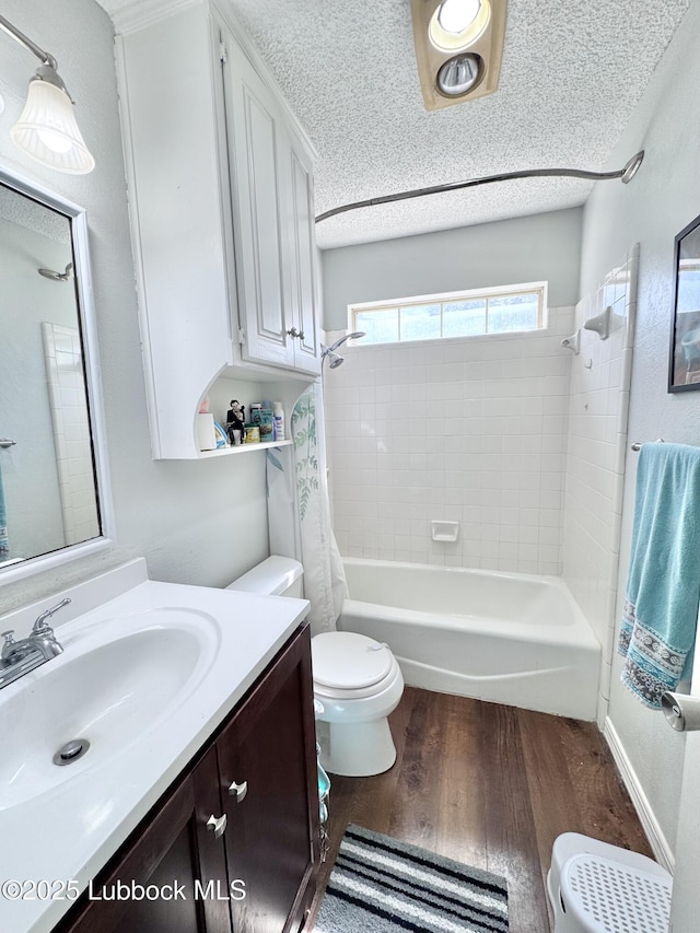 5623 87th St, Lubbock, TX 79424 - bathroom featuring toilet, shower / tub combo, vanity, wood finished floors, and a textured ceiling