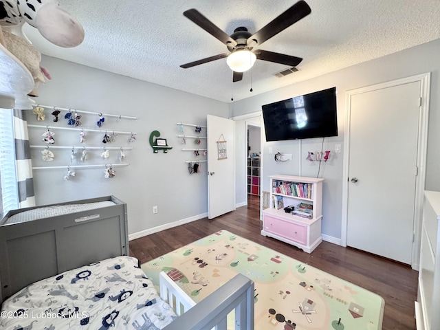 5623 87th St, Lubbock, TX 79424 - bedroom featuring wood finished floors, a textured ceiling, baseboards, and ceiling fan