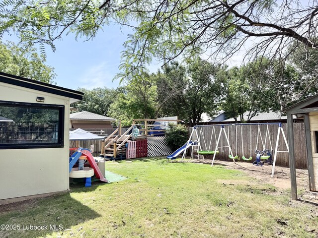 5623 87th St, Lubbock, TX 79424 - view of yard featuring a playground and a deck