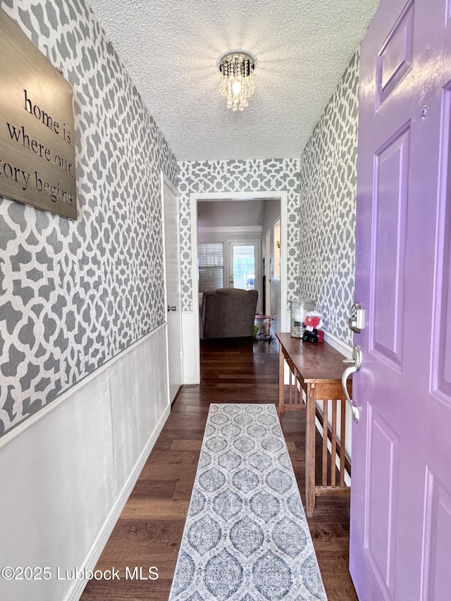 5623 87th St, Lubbock, TX 79424 - hall with wallpapered walls, wood finished floors, and a textured ceiling