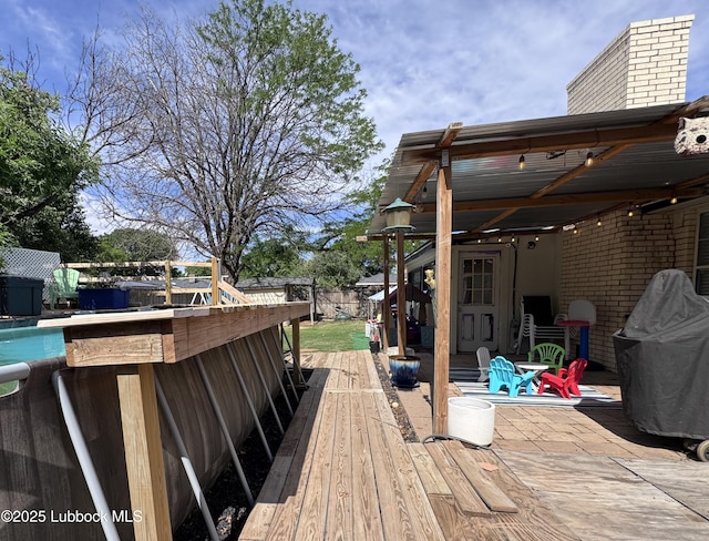 5623 87th St, Lubbock, TX 79424 - wooden deck featuring an outdoor pool and a patio area