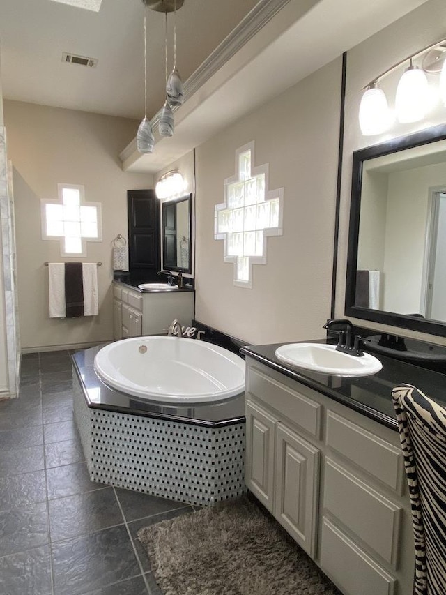 bathroom featuring a relaxing tiled tub and vanity