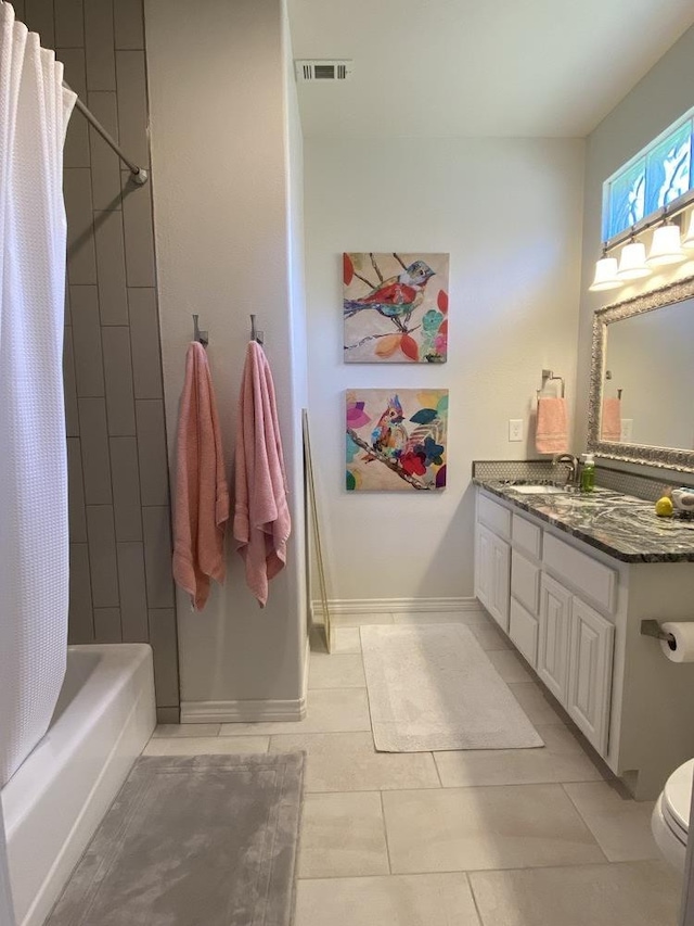 full bathroom with vanity, toilet, tile patterned flooring, and shower / bath combo