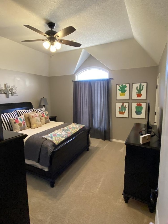 bedroom featuring ceiling fan, vaulted ceiling, a textured ceiling, and carpet flooring