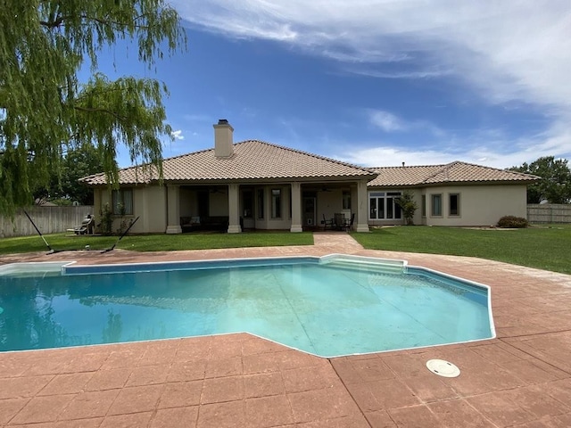 view of pool featuring a lawn and a patio area