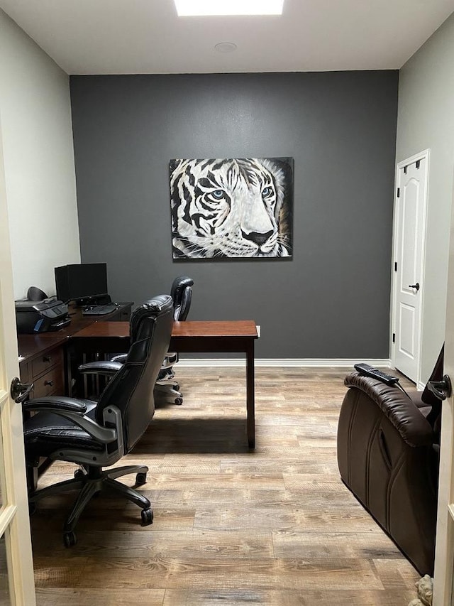 home office with light hardwood / wood-style floors