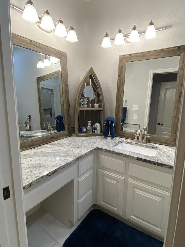 bathroom with tile patterned floors and vanity