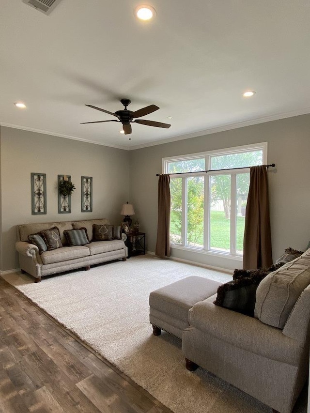 living room featuring crown molding, ceiling fan, and hardwood / wood-style floors