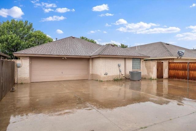 exterior space featuring a garage and central AC