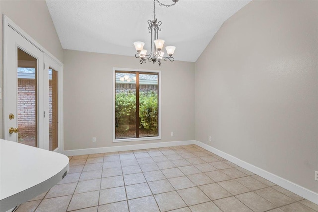 unfurnished dining area featuring an inviting chandelier, light tile patterned floors, vaulted ceiling, and a textured ceiling