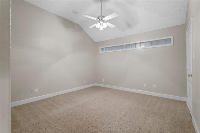 carpeted spare room featuring lofted ceiling and ceiling fan