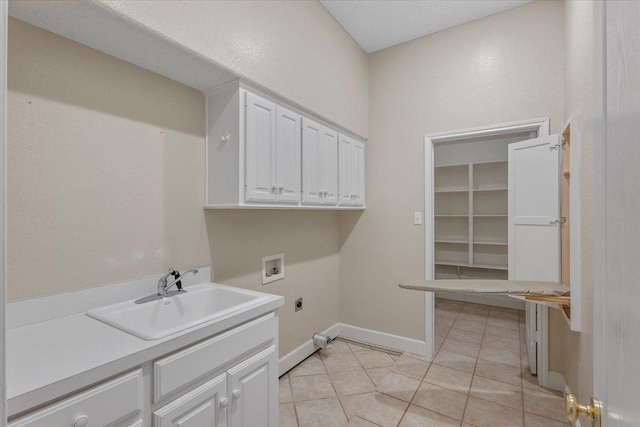 laundry area featuring light tile patterned flooring, sink, cabinets, electric dryer hookup, and washer hookup