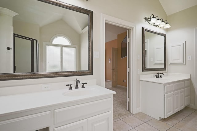 bathroom with lofted ceiling, vanity, and tile patterned floors