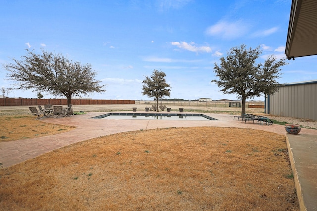 view of yard featuring a fenced in pool and a patio