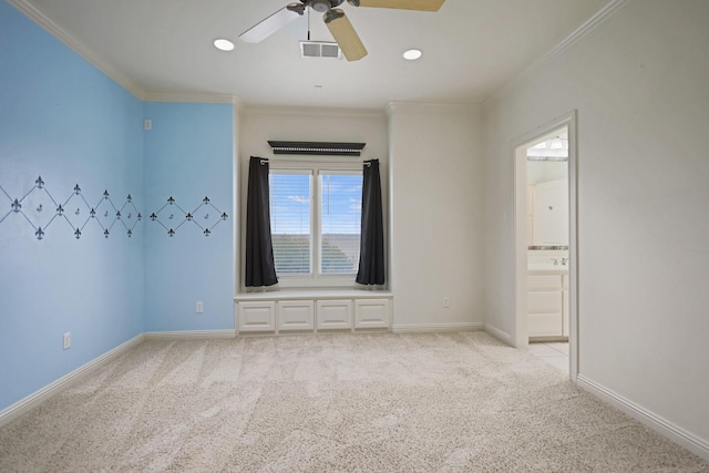 carpeted empty room featuring ornamental molding and ceiling fan