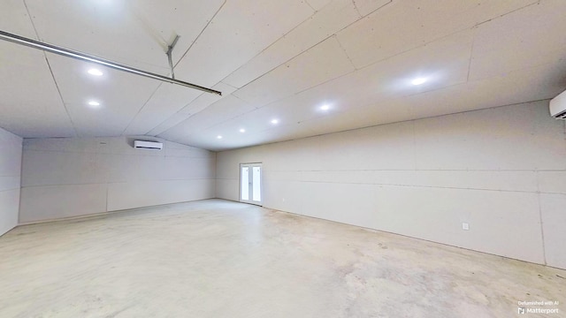 spare room featuring lofted ceiling and a wall mounted AC