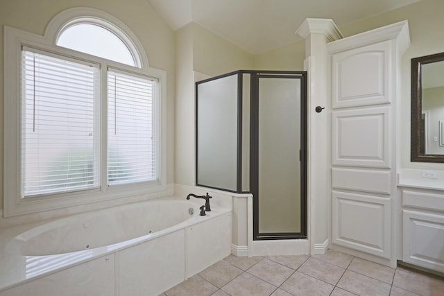 bathroom featuring tile patterned flooring, shower with separate bathtub, and a wealth of natural light