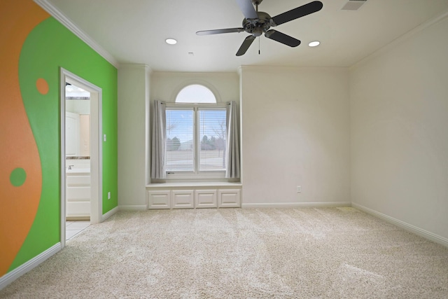 carpeted spare room featuring ornamental molding and ceiling fan