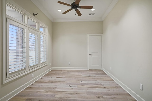 empty room with crown molding, ceiling fan, and light wood-type flooring