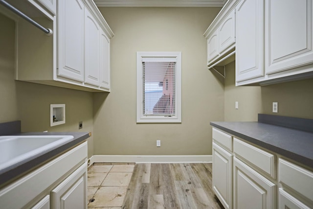 laundry room featuring sink, cabinets, light wood-type flooring, hookup for a washing machine, and electric dryer hookup