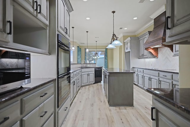 kitchen with gray cabinets, tasteful backsplash, ornamental molding, black appliances, and decorative light fixtures