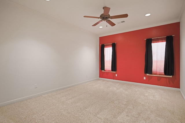 empty room featuring ornamental molding, ceiling fan, and carpet flooring