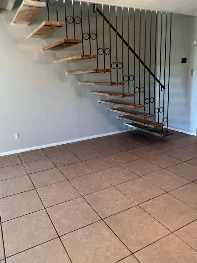 stairway with tile patterned flooring