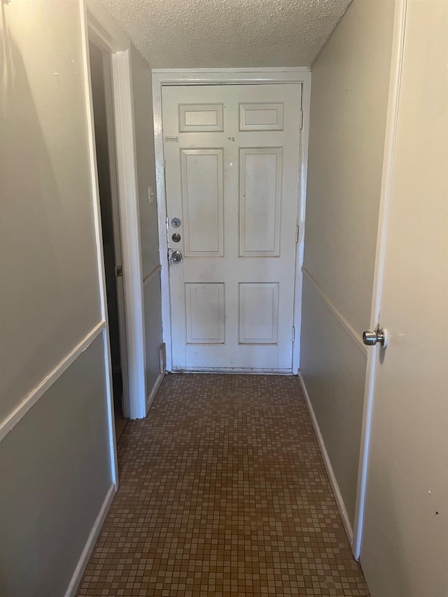 hallway featuring a textured ceiling