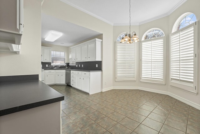 kitchen featuring white cabinetry, decorative light fixtures, an inviting chandelier, and light tile patterned floors