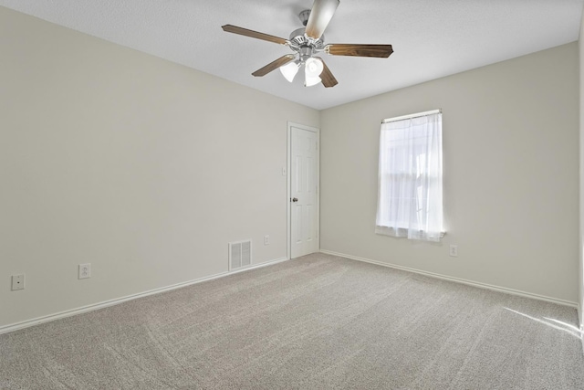 unfurnished room featuring light carpet and ceiling fan