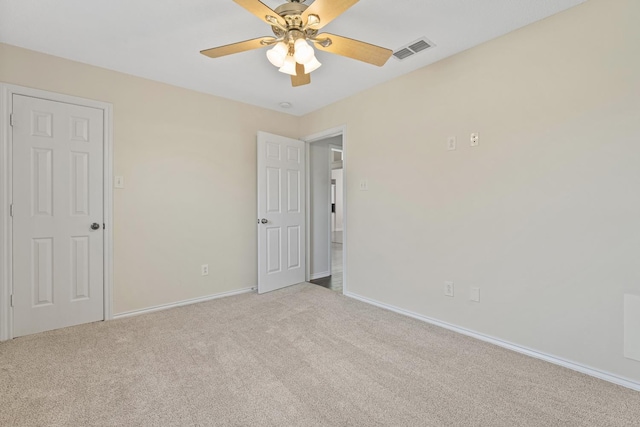 carpeted spare room with ceiling fan