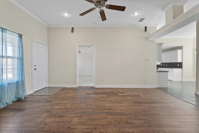 empty room with ornamental molding, plenty of natural light, dark hardwood / wood-style floors, and ceiling fan