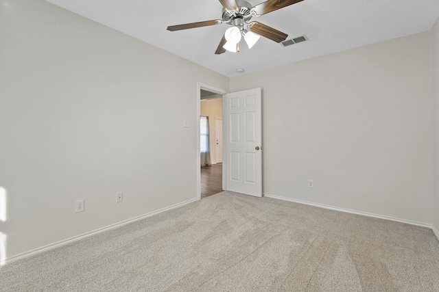 carpeted empty room with ceiling fan