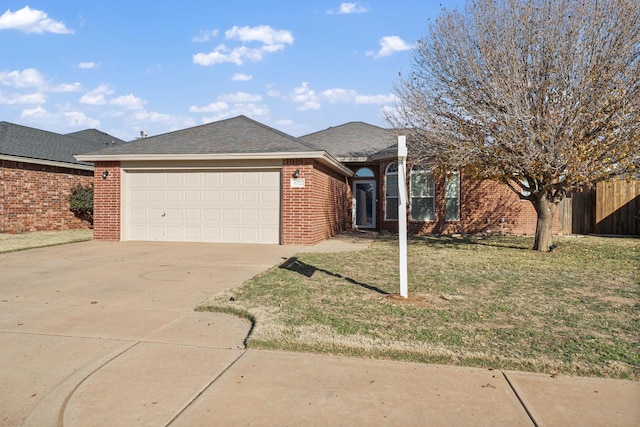 ranch-style home featuring a garage and a front yard